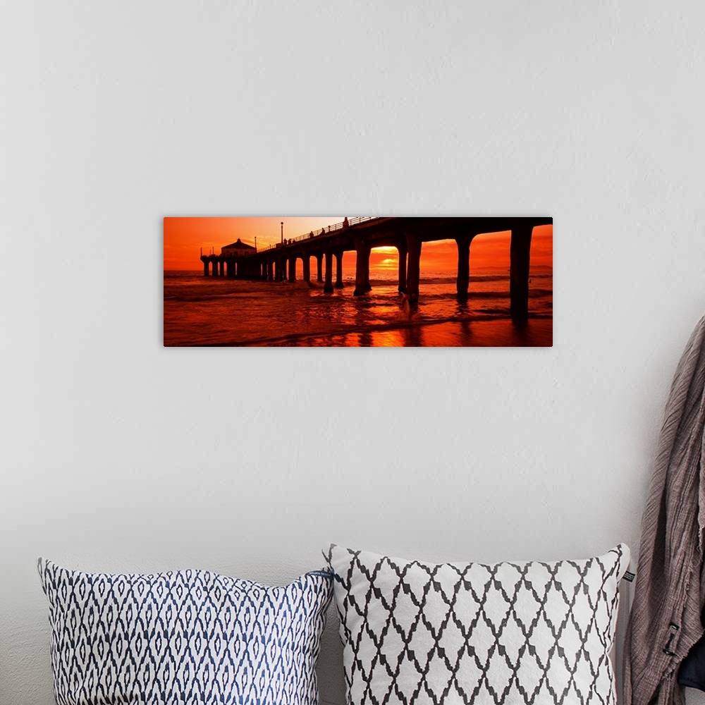 A bohemian room featuring Panoramic photograph on a big canvas of a silhouetted Manhattan Beach Pier at an angle, in front ...