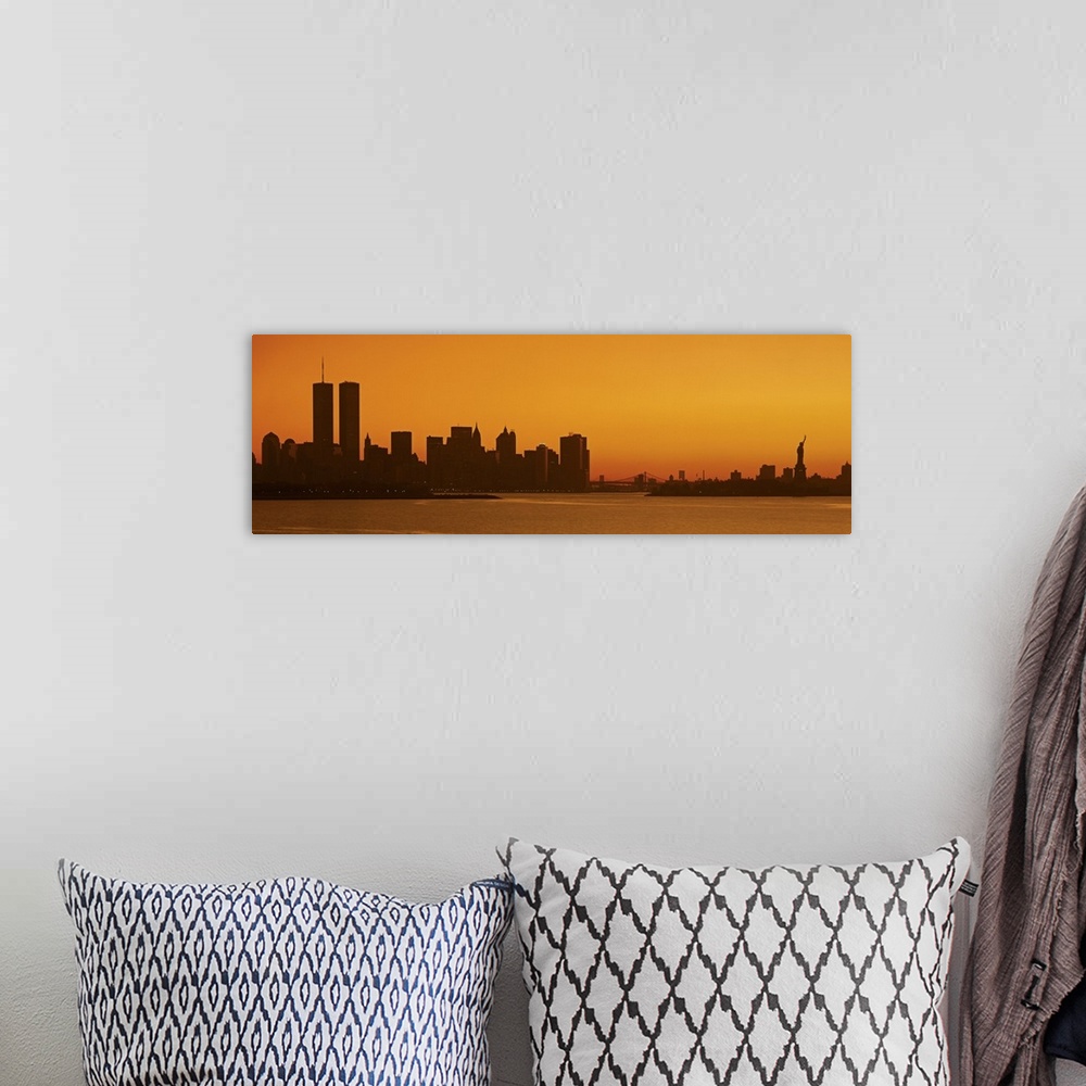 A bohemian room featuring Panoramic photo of the silhouette of the NYC cityscape against a warm sunset.