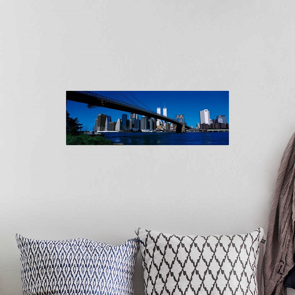A bohemian room featuring Panoramic photo print of the Brooklyn Bridge that leads towards the skyline of downtown New York ...