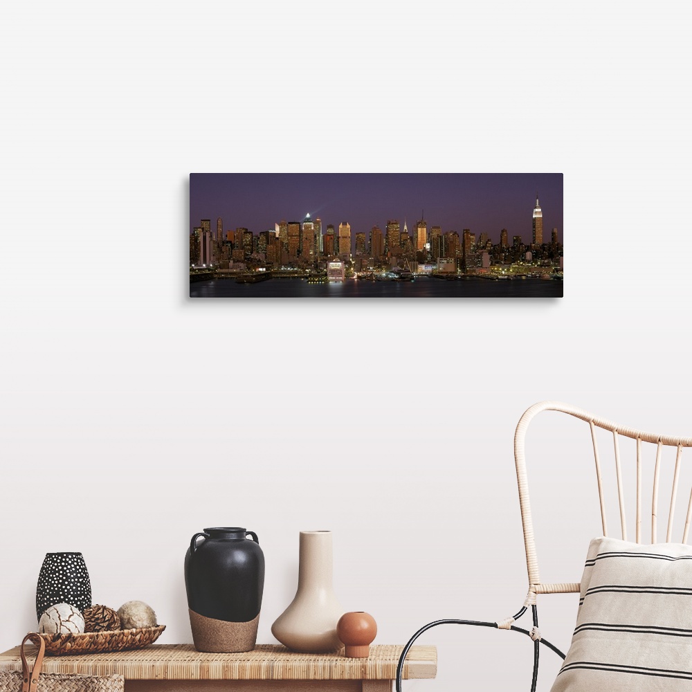 A farmhouse room featuring Wide angel, distant photograph of the Manhattan skyline, lit at night, beneath a deep purple sky ...