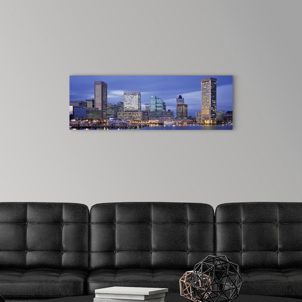 A modern room featuring This large panoramic photograph is of the Baltimore skyline at dusk with cool colors and the buli...