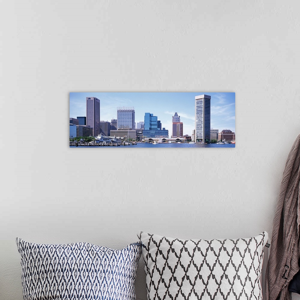 A bohemian room featuring Buildings that sit on the inner harbor in Baltimore are photographed with a wide angle lens.