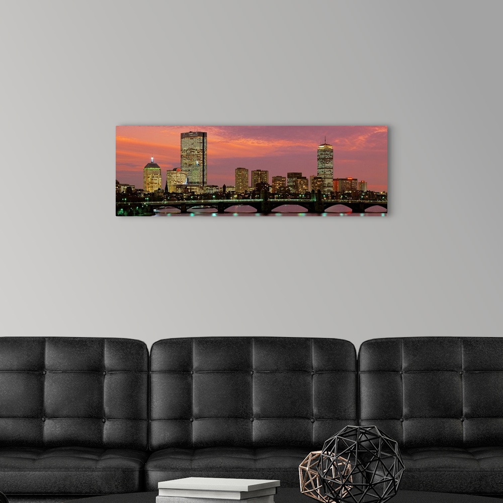 A modern room featuring Large horizontal wall picture of the Boston city skyline at dusk with the Charles River Bridge in...