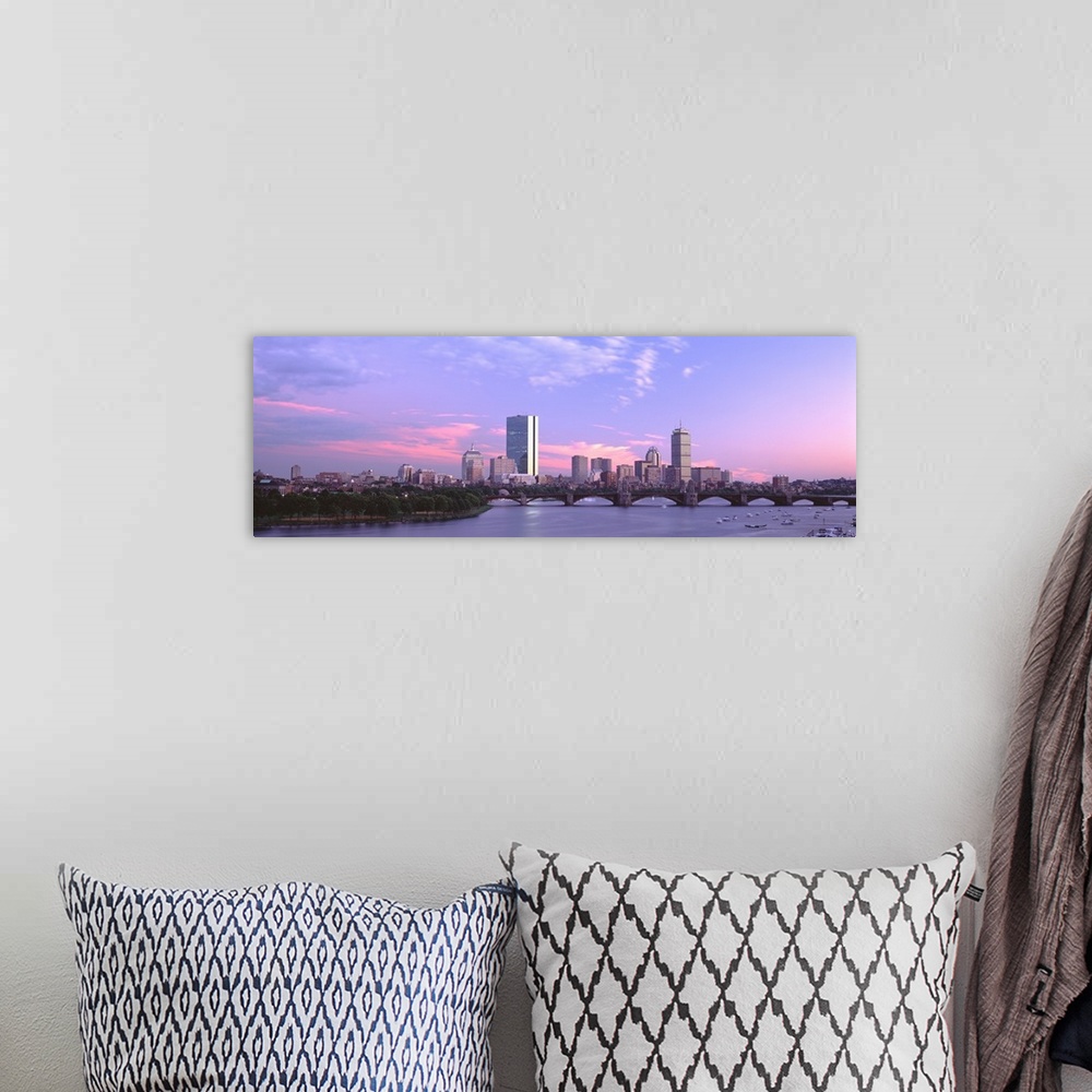A bohemian room featuring Landscape photograph of the Boston skyline beneath a vibrant sky at dusk, the Longfellow Bridge o...