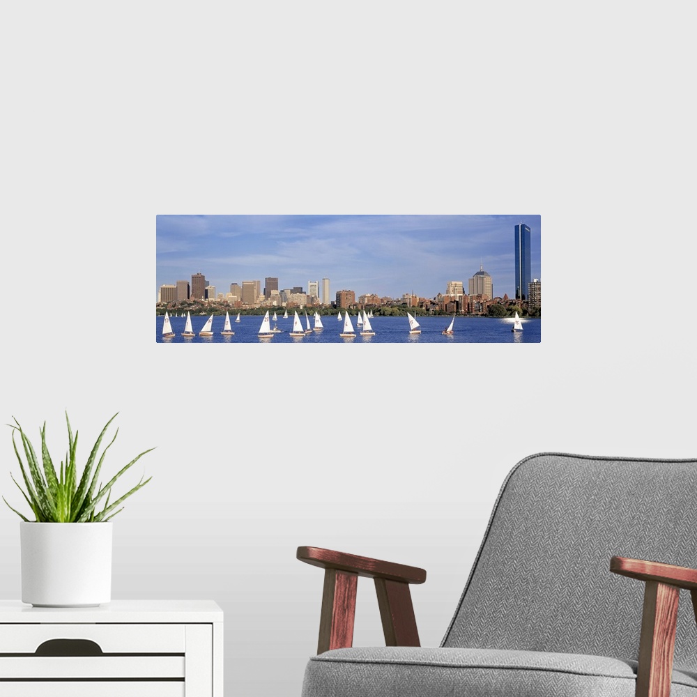 A modern room featuring Giant landscape photograph of many sailboats in the Charles River, the Boston skyline in the back...