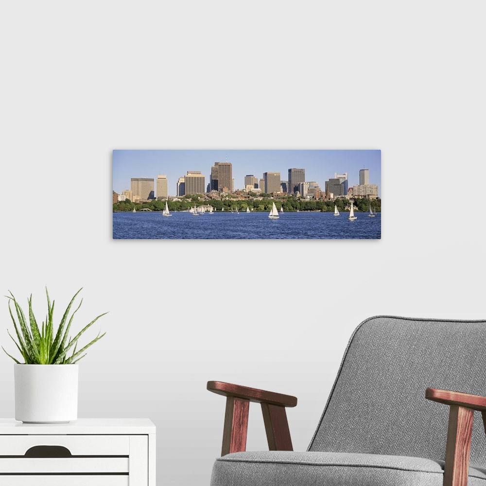 A modern room featuring Panoramic photograph of skyscrapers filling the horizon in a busy city.  Within the bay in the fo...