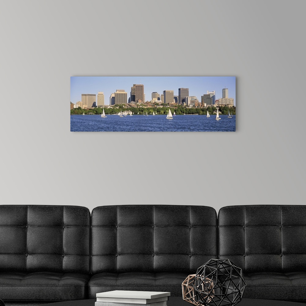 A modern room featuring Panoramic photograph of skyscrapers filling the horizon in a busy city.  Within the bay in the fo...