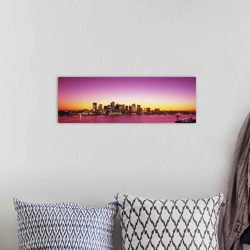 A bohemian room featuring Big, wide angle photograph of a distant Boston skyline, with lit skyscrapers at sunset.