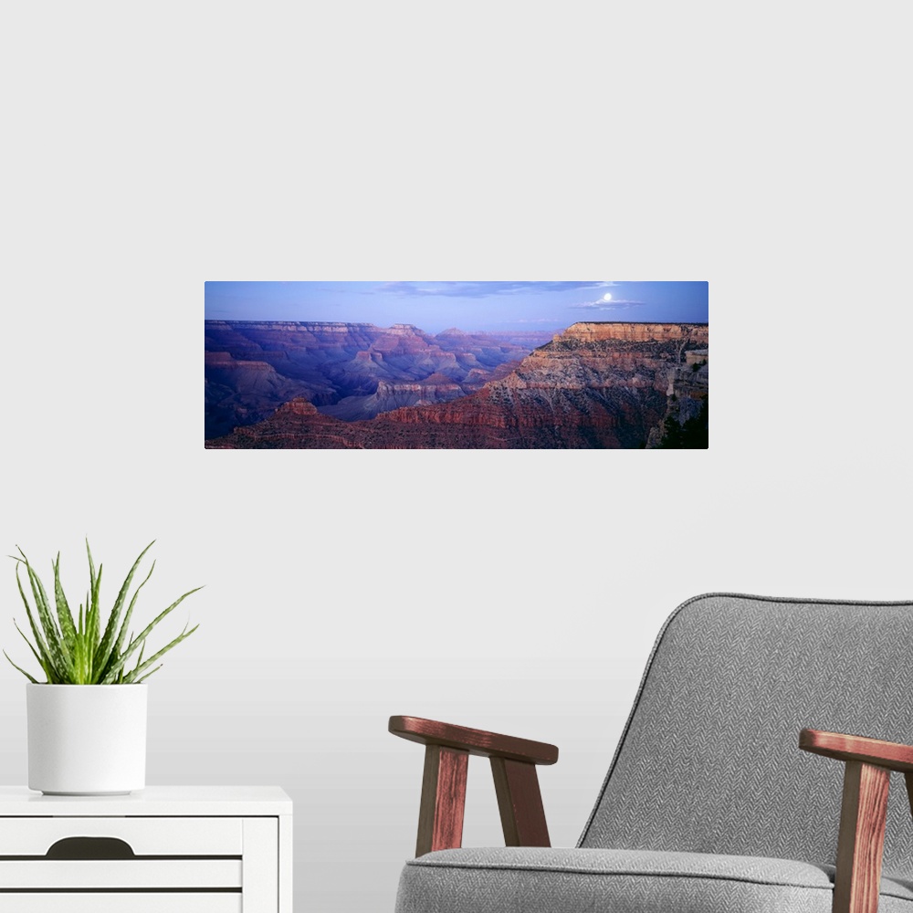 A modern room featuring Big panoramic photo from Mather Point in the Grand Canyon in Arizona (AZ) at dusk on a night with...