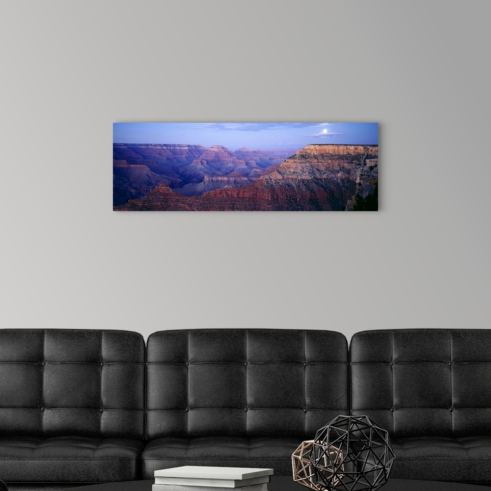 A modern room featuring Big panoramic photo from Mather Point in the Grand Canyon in Arizona (AZ) at dusk on a night with...