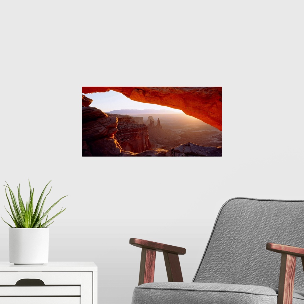 A modern room featuring Wall art for the home or office this big picture shows a view of the desert at sunrise through a ...
