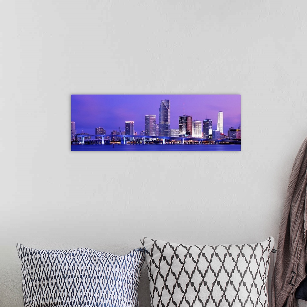 A bohemian room featuring Wide angle photograph of brightly lit bridge and  skyscrapers of the Miami skyline at sunset.