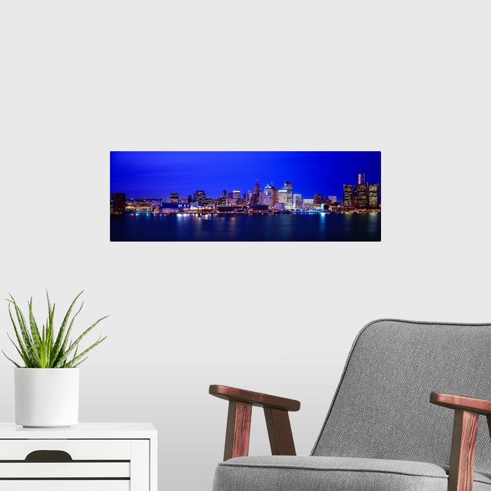 A modern room featuring Night view of Detroit's downtown skyline.