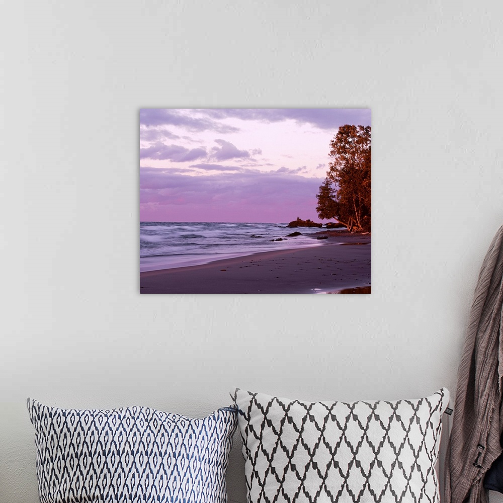 A bohemian room featuring Picture of waves in Lake Superior crashing on to the beach as the sun sets and lights up the sky ...