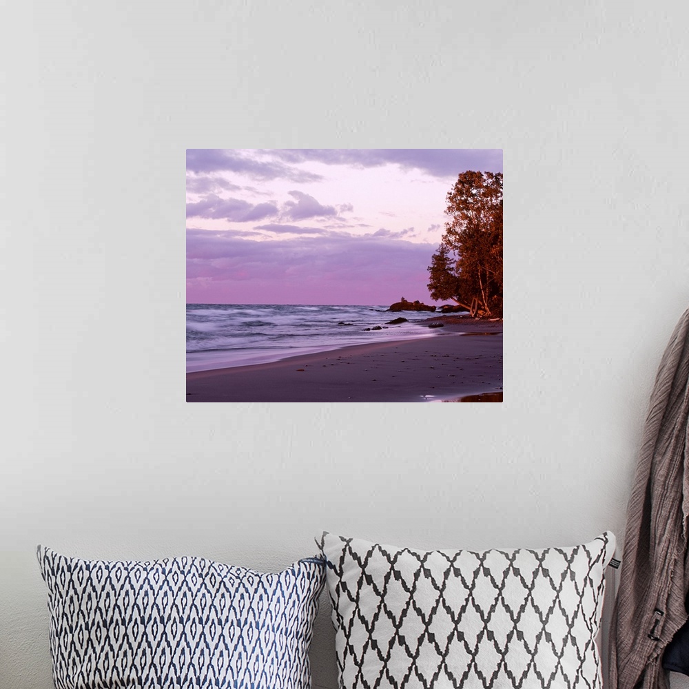 A bohemian room featuring Picture of waves in Lake Superior crashing on to the beach as the sun sets and lights up the sky ...
