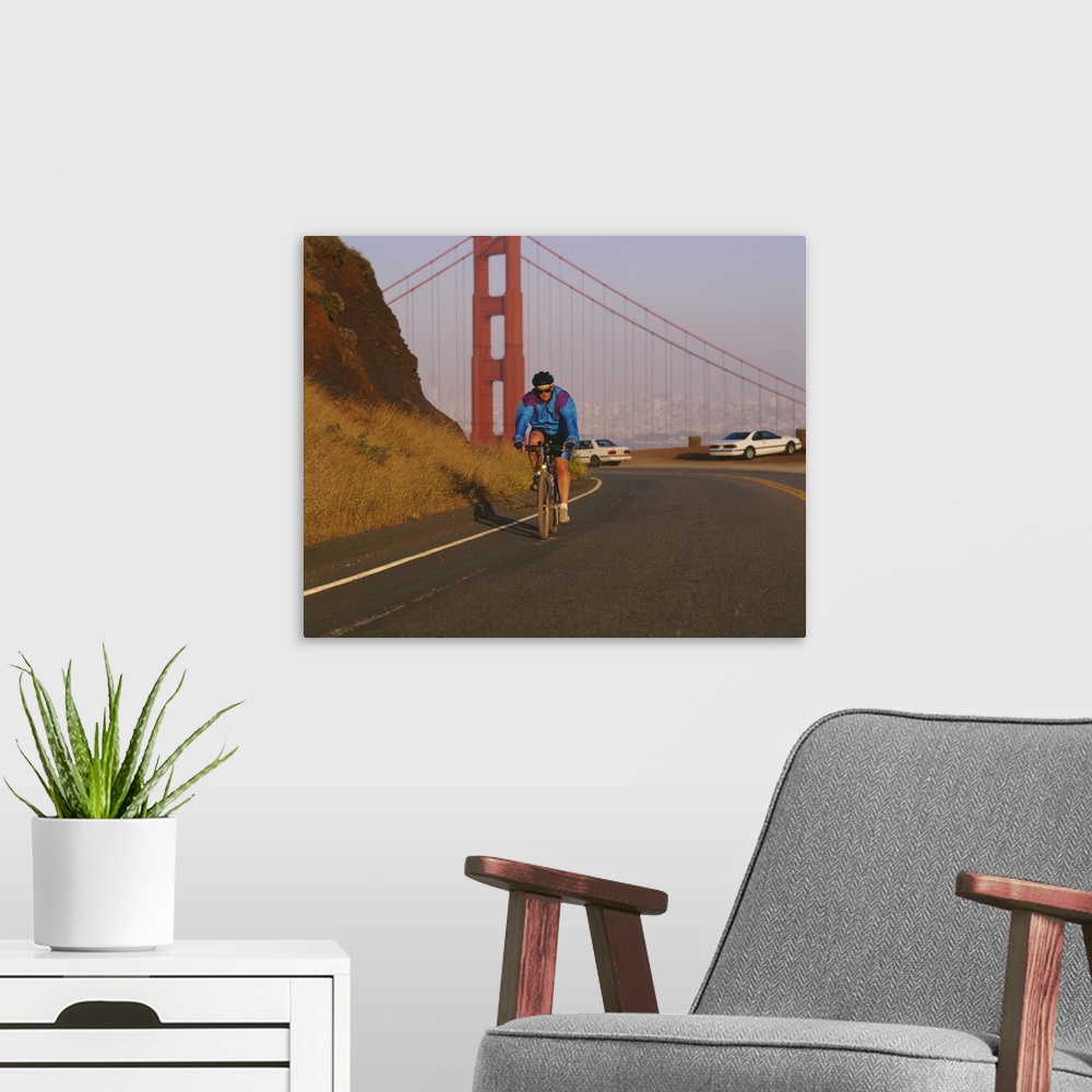 A modern room featuring Mid adult man cycling, Golden Gate Bridge, San Francisco, California