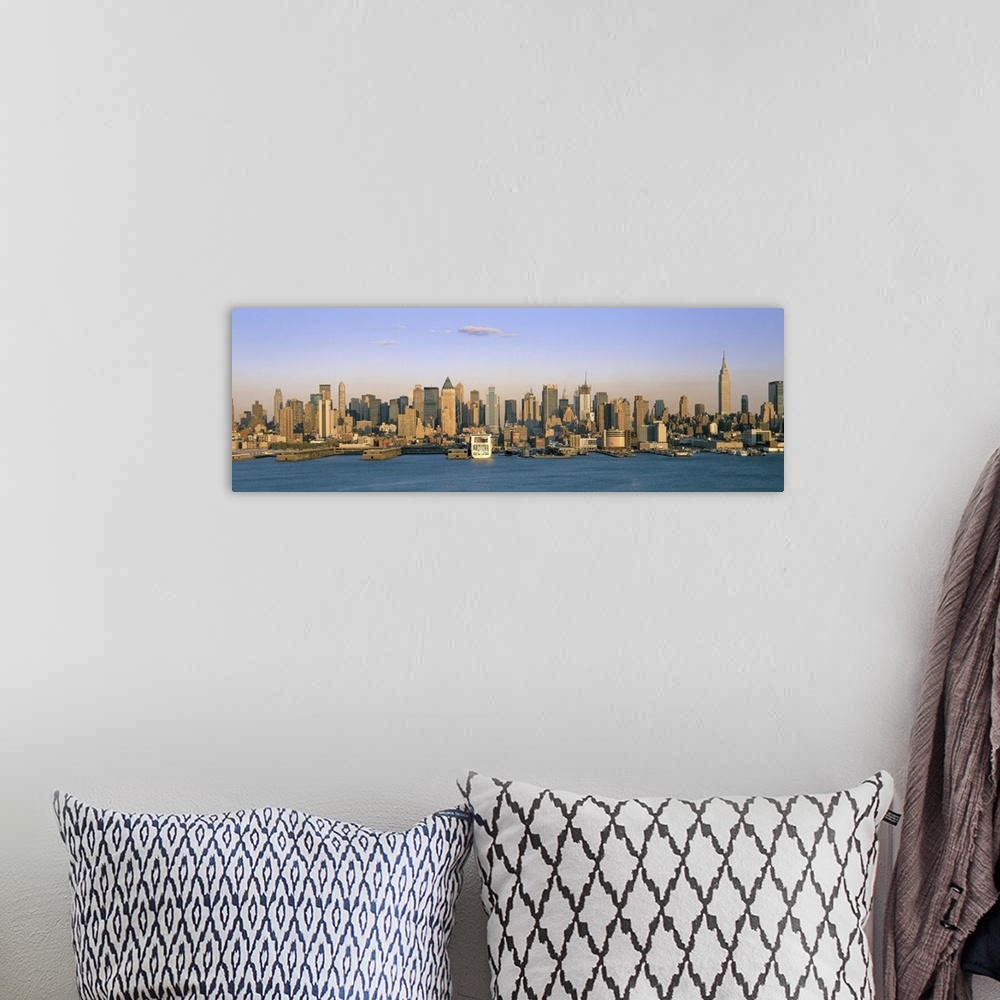 A bohemian room featuring Long horizontal photo print of the NYC cityscape meeting the water.
