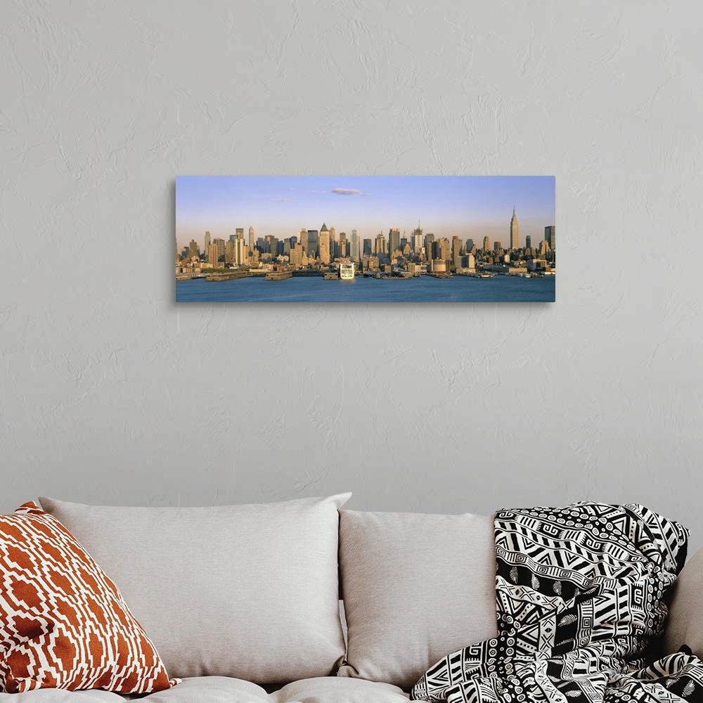 A bohemian room featuring Long horizontal photo print of the NYC cityscape meeting the water.