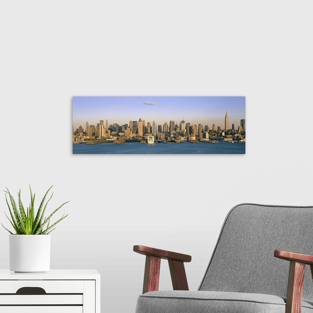 A modern room featuring Long horizontal photo print of the NYC cityscape meeting the water.