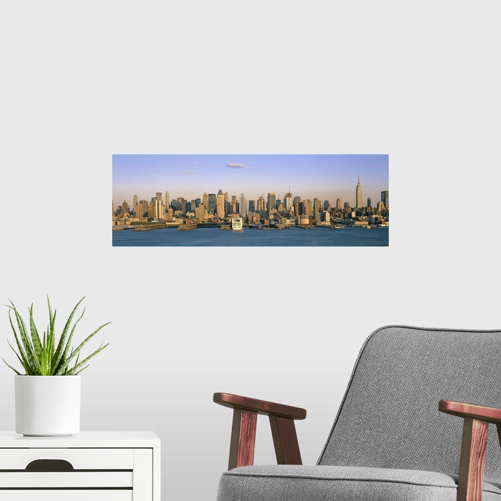 A modern room featuring Long horizontal photo print of the NYC cityscape meeting the water.