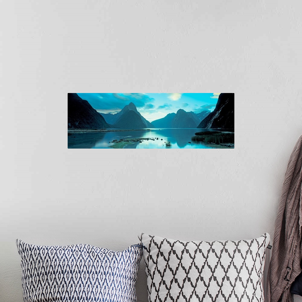 A bohemian room featuring Mountains reflecting in the smooth surface of a lake in this landscape panoramic photograph.