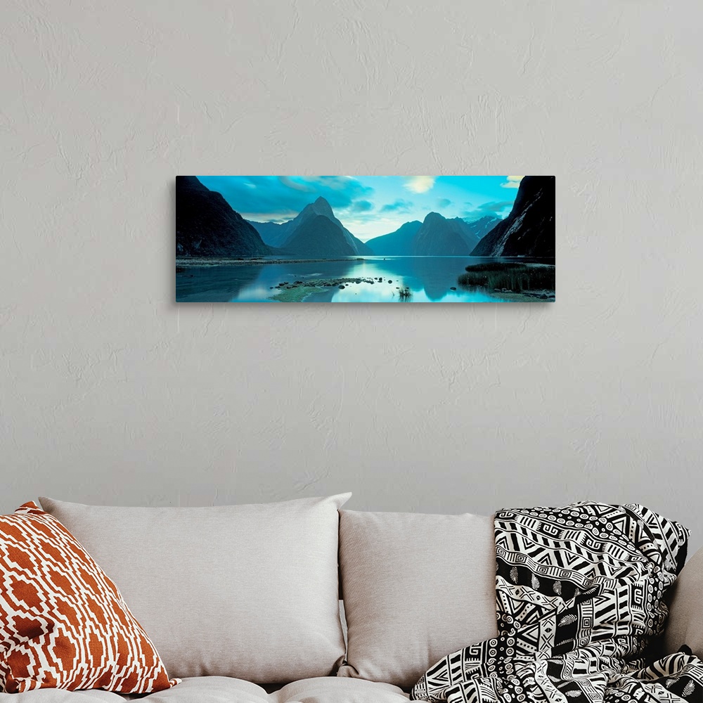 A bohemian room featuring Mountains reflecting in the smooth surface of a lake in this landscape panoramic photograph.