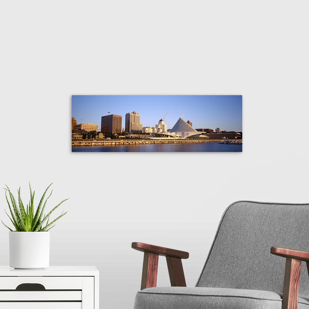 A modern room featuring Panoramic photograph on a big canvas of buildings on the water in Milwaukee, Wisconsin, including...
