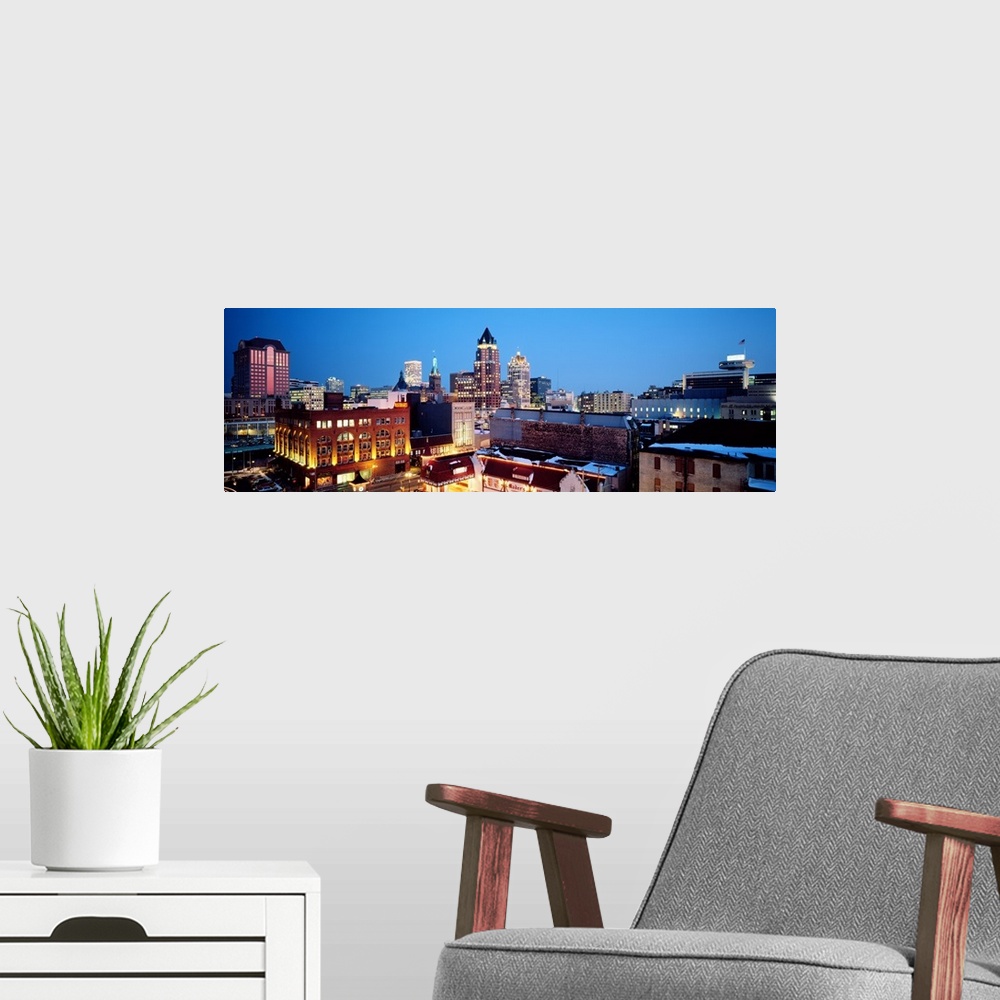 A modern room featuring Early evening photograph of the largest city in Wisconsin, with the lights of the buildings start...