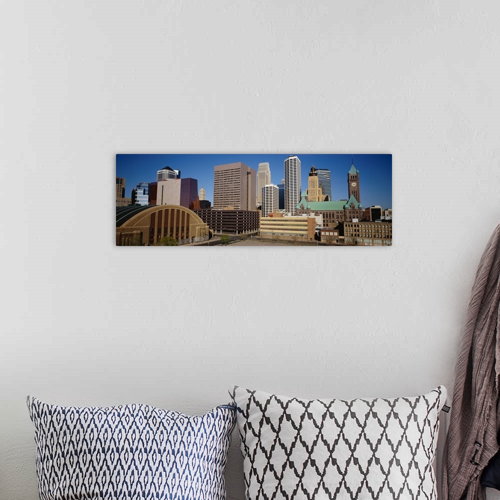 A bohemian room featuring Big, panoramic photograph of the Minneapolis skyline against a blue, afternoon sky.