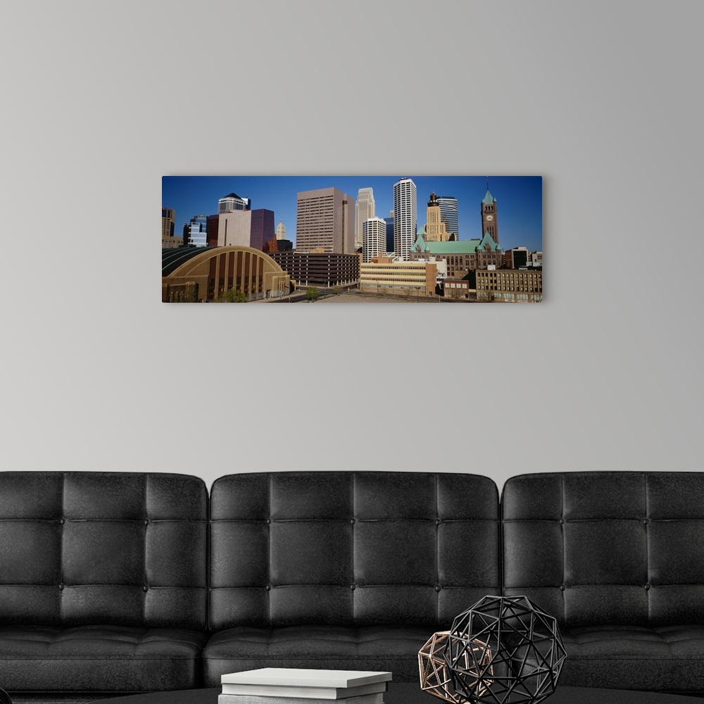 A modern room featuring Big, panoramic photograph of the Minneapolis skyline against a blue, afternoon sky.