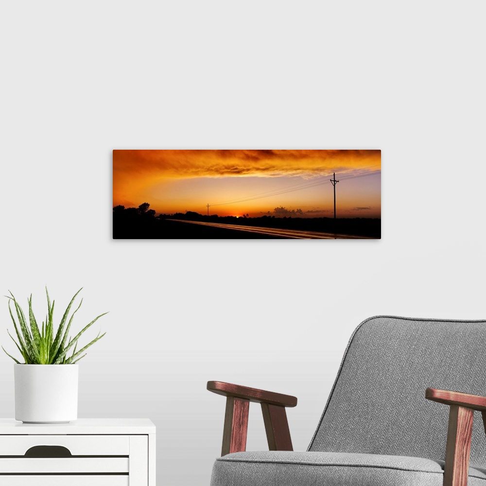 A modern room featuring Missouri, Riverton, Route 66, View of clouds over a highway at dusk
