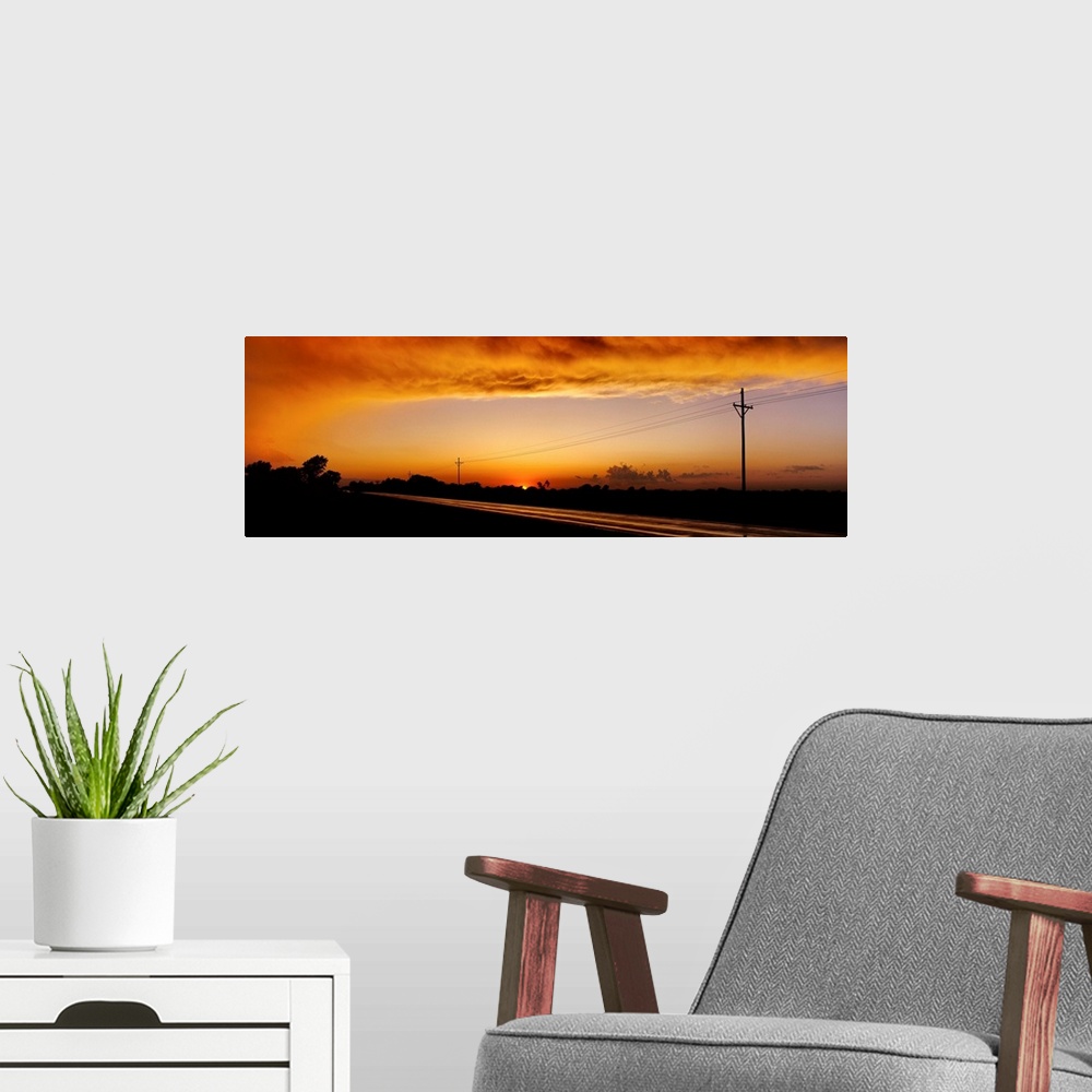A modern room featuring Missouri, Riverton, Route 66, View of clouds over a highway at dusk