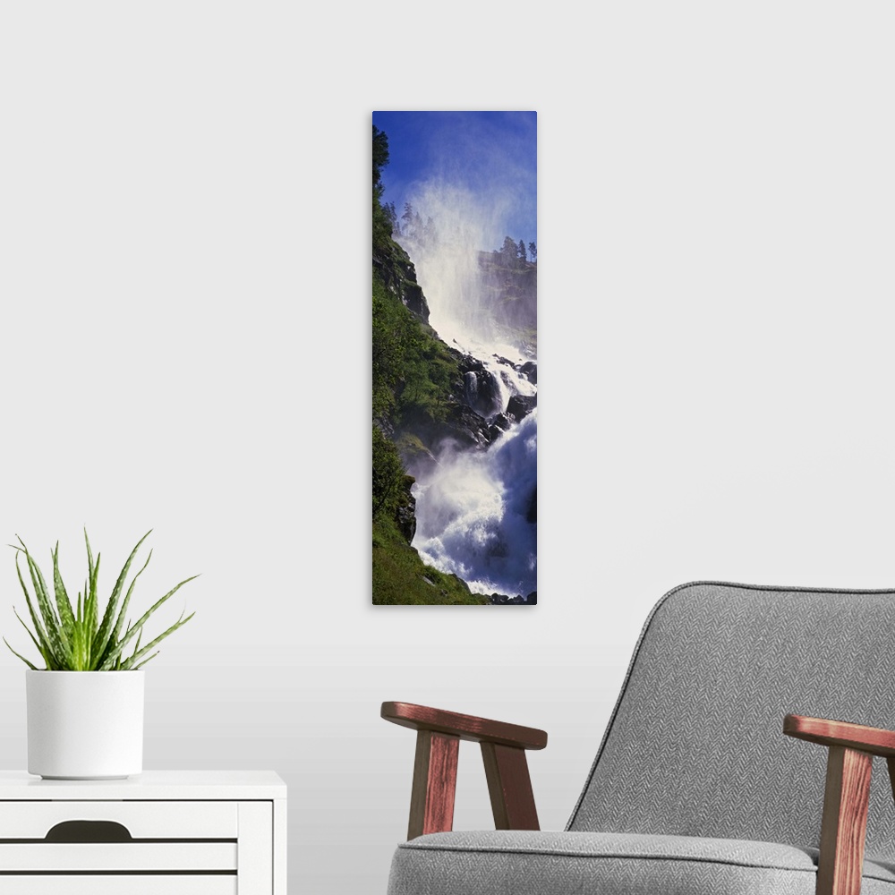 A modern room featuring Mist on rocky mountain waterfall, spring foliage, Norway