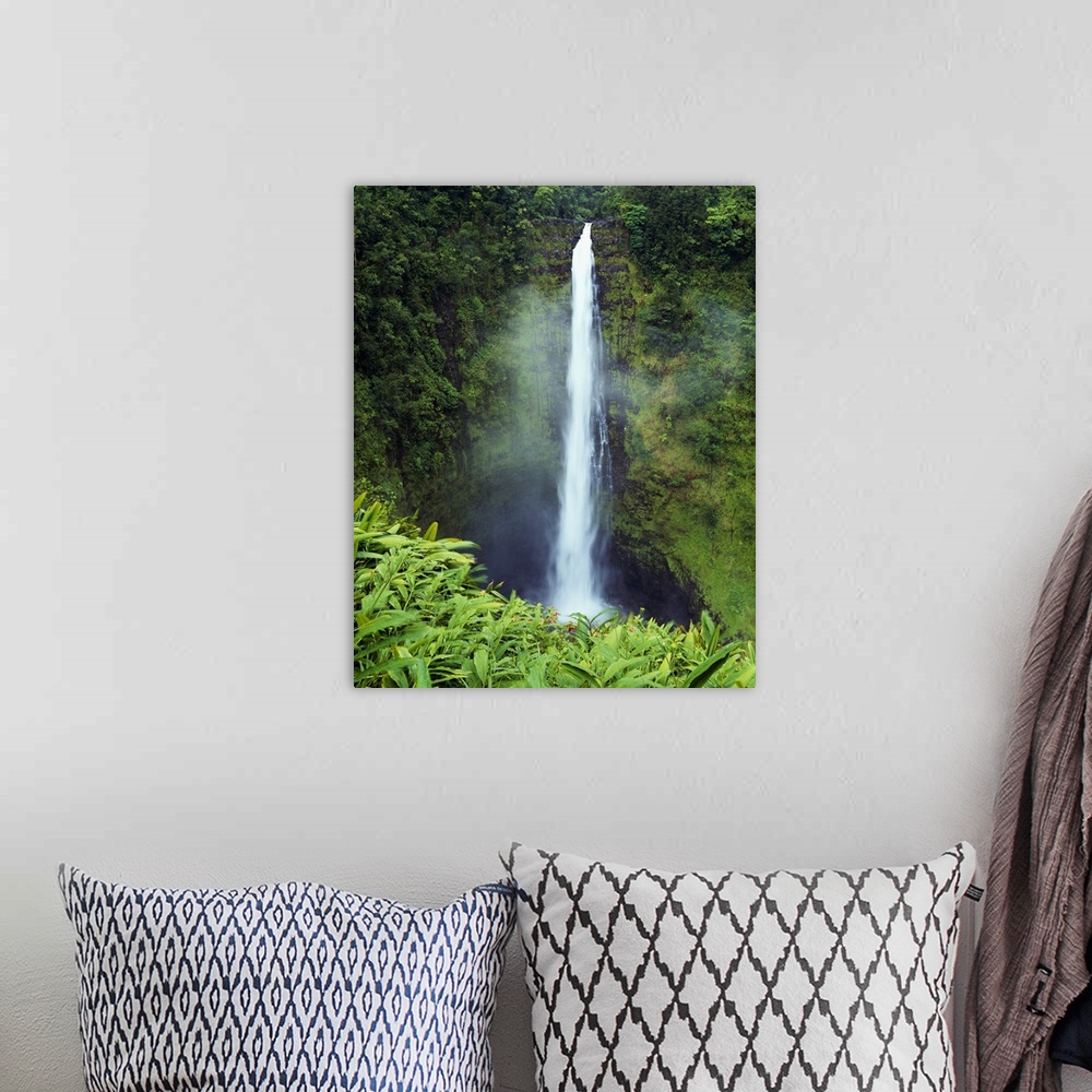 A bohemian room featuring Big canvas photo art of a narrow waterfall cascading down a cliff in Hawaii.
