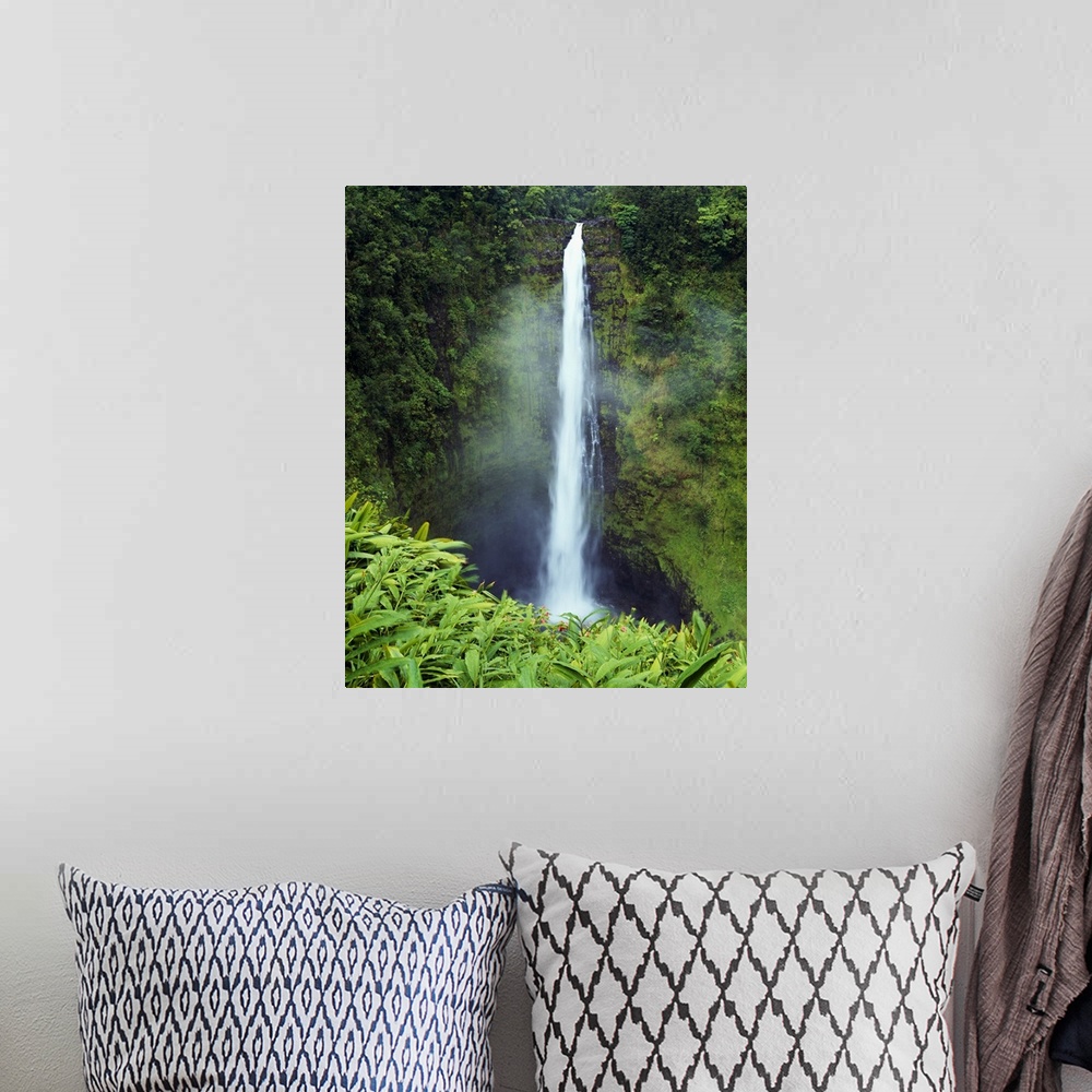 A bohemian room featuring Big canvas photo art of a narrow waterfall cascading down a cliff in Hawaii.