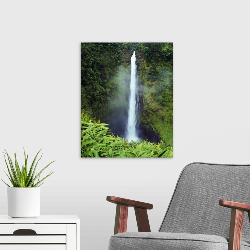 A modern room featuring Big canvas photo art of a narrow waterfall cascading down a cliff in Hawaii.