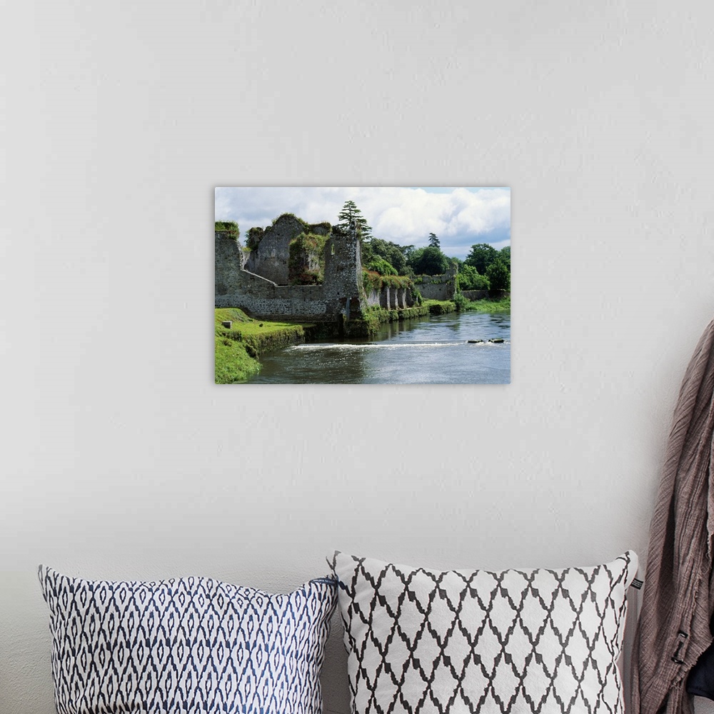 A bohemian room featuring Photograph of grass covered stone castle ruins in Ireland with a moat surrounding the castle walls.