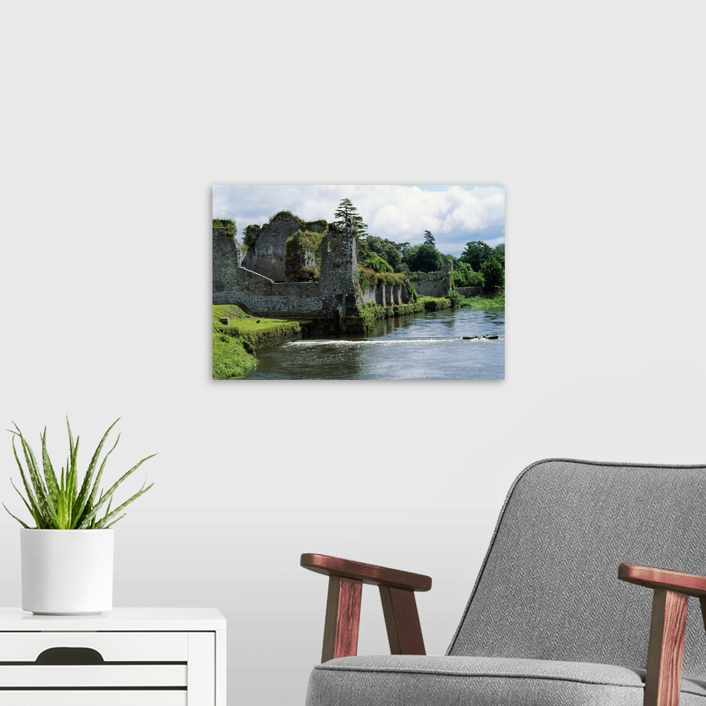 A modern room featuring Photograph of grass covered stone castle ruins in Ireland with a moat surrounding the castle walls.