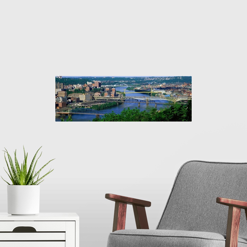 A modern room featuring Big, horizontal, high angle photograph of numerous bridges crossing the Monongahela River, surrou...