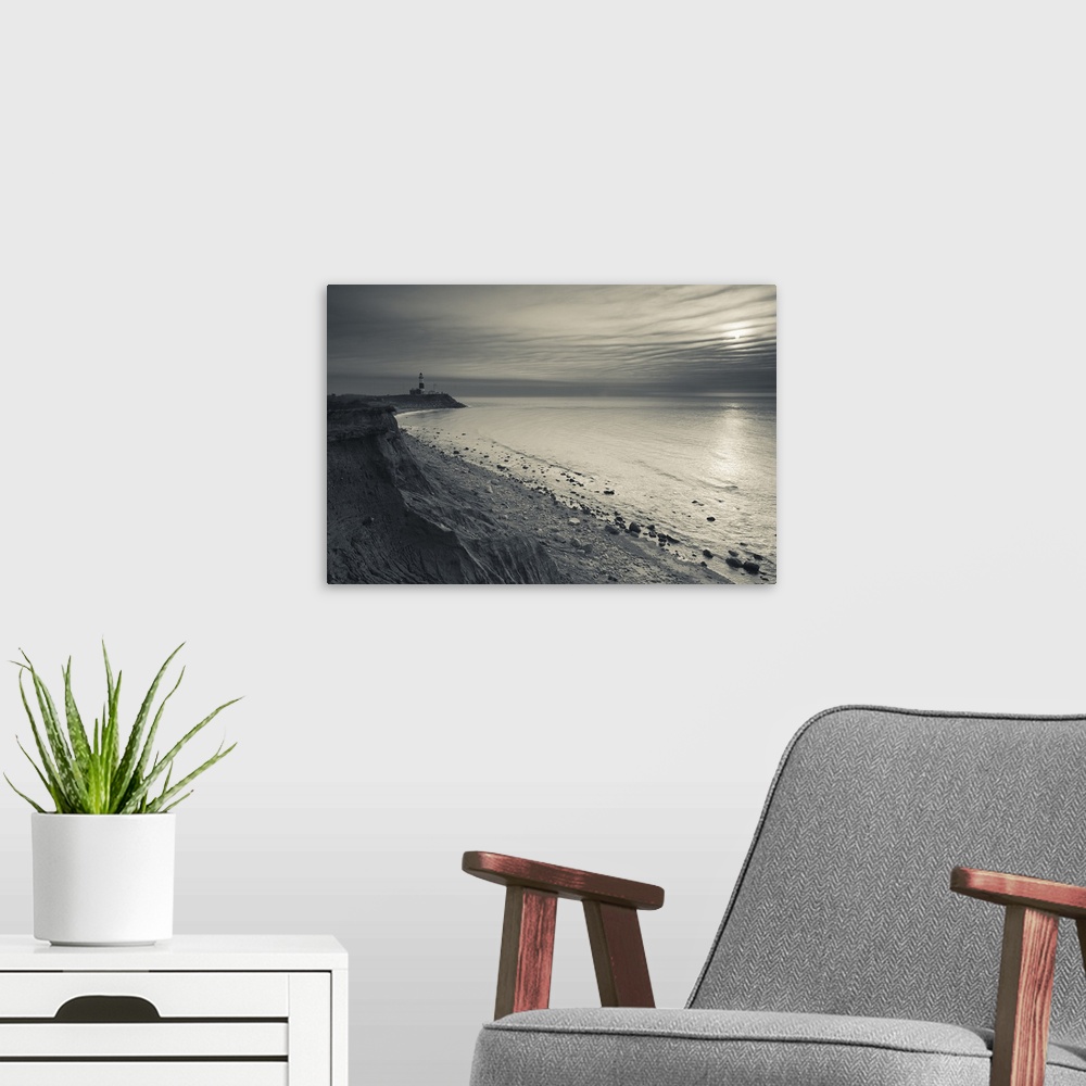 A modern room featuring This is a landscape photograph of the shoreline on a partially cloud day.