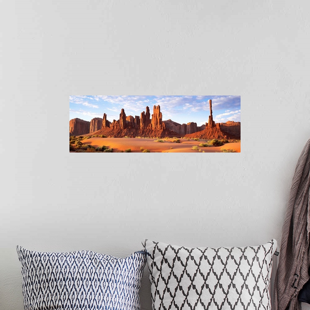 A bohemian room featuring Panoramic photograph composed of a desert landscape filled with sand and small patches of vegetat...