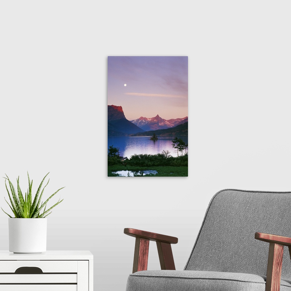 A modern room featuring Big, portrait photograph of Saint Mary's Lake in Glacier National Park.  The moonlight is reflect...