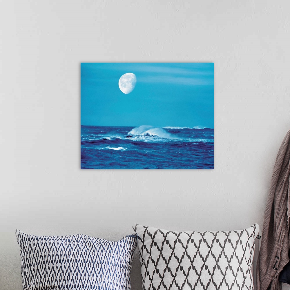 A bohemian room featuring Moon over waves in sea