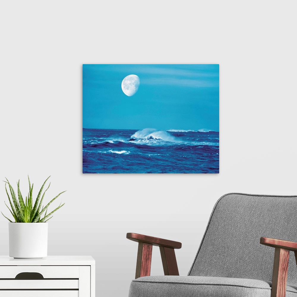 A modern room featuring Moon over waves in sea
