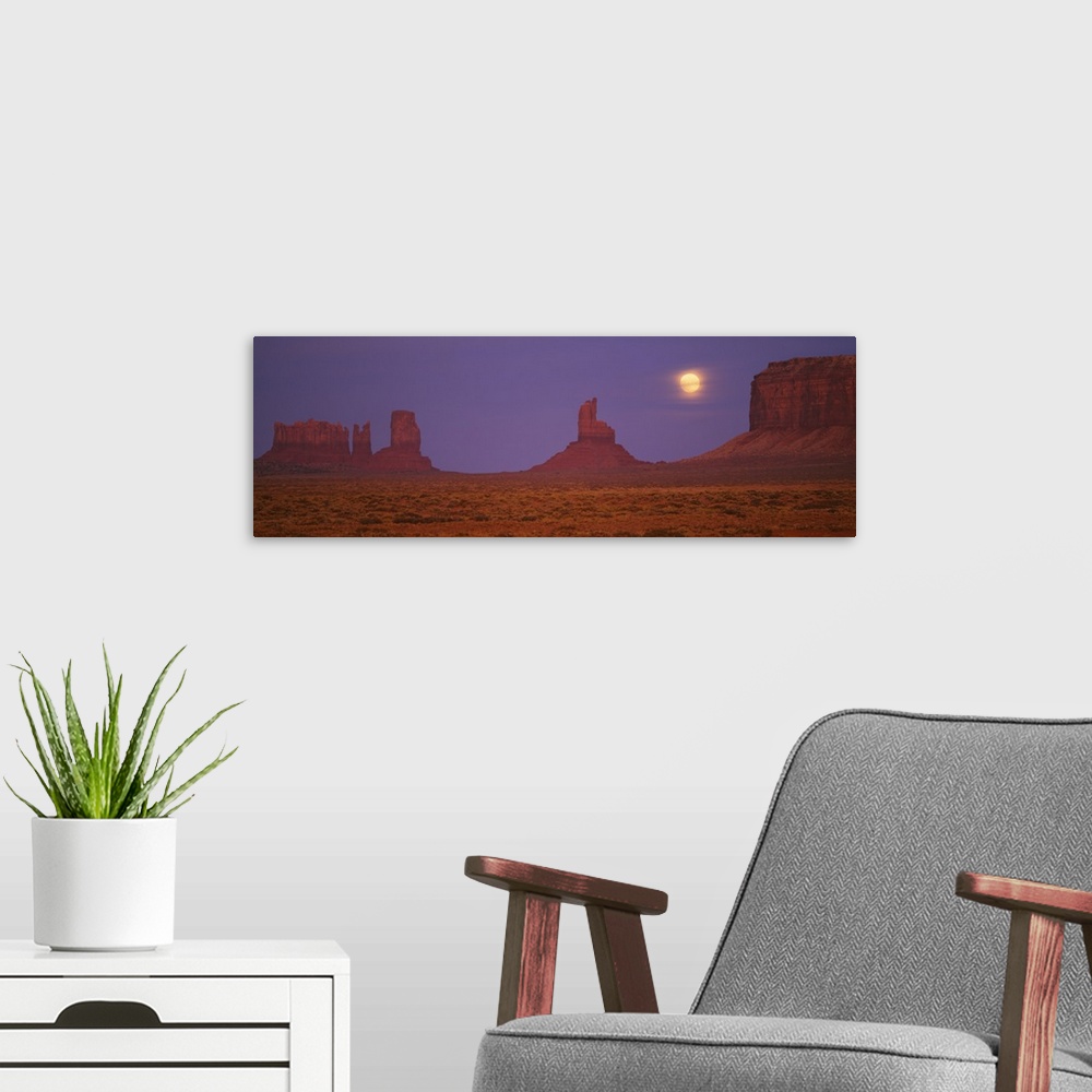 A modern room featuring Moon shining over rock formations, Monument Valley Tribal Park, Arizona