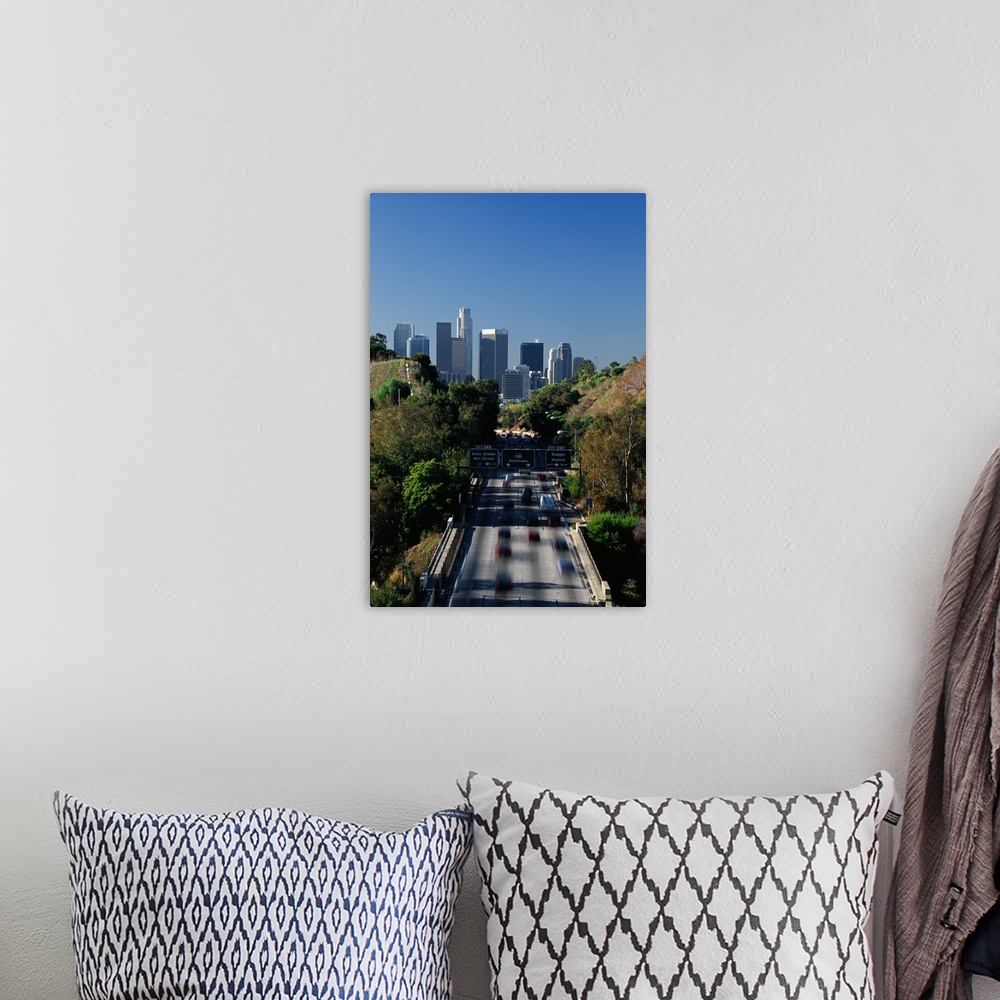 A bohemian room featuring This large vertical piece is a photograph taken of the Pasadena freeway during a morning commute....