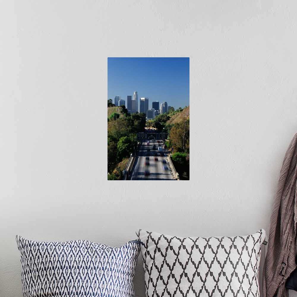 A bohemian room featuring This large vertical piece is a photograph taken of the Pasadena freeway during a morning commute....