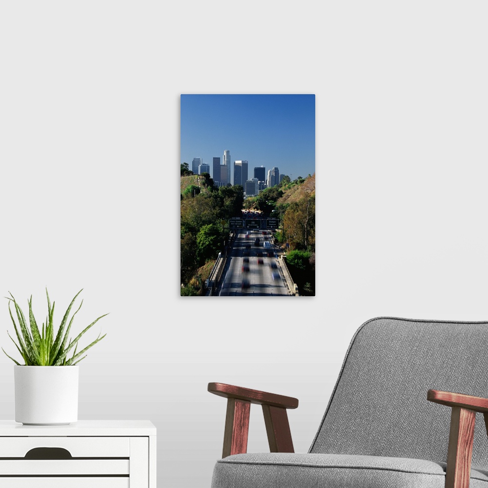 A modern room featuring This large vertical piece is a photograph taken of the Pasadena freeway during a morning commute....