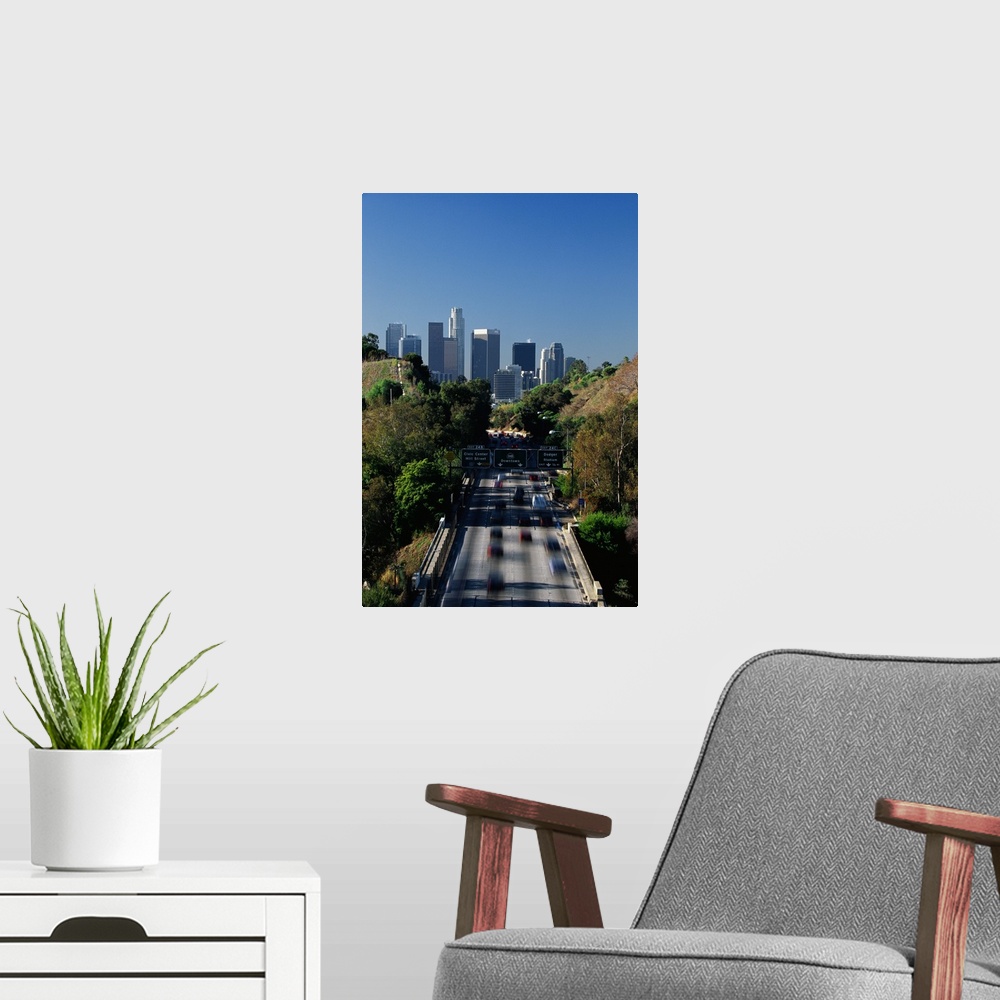 A modern room featuring This large vertical piece is a photograph taken of the Pasadena freeway during a morning commute....