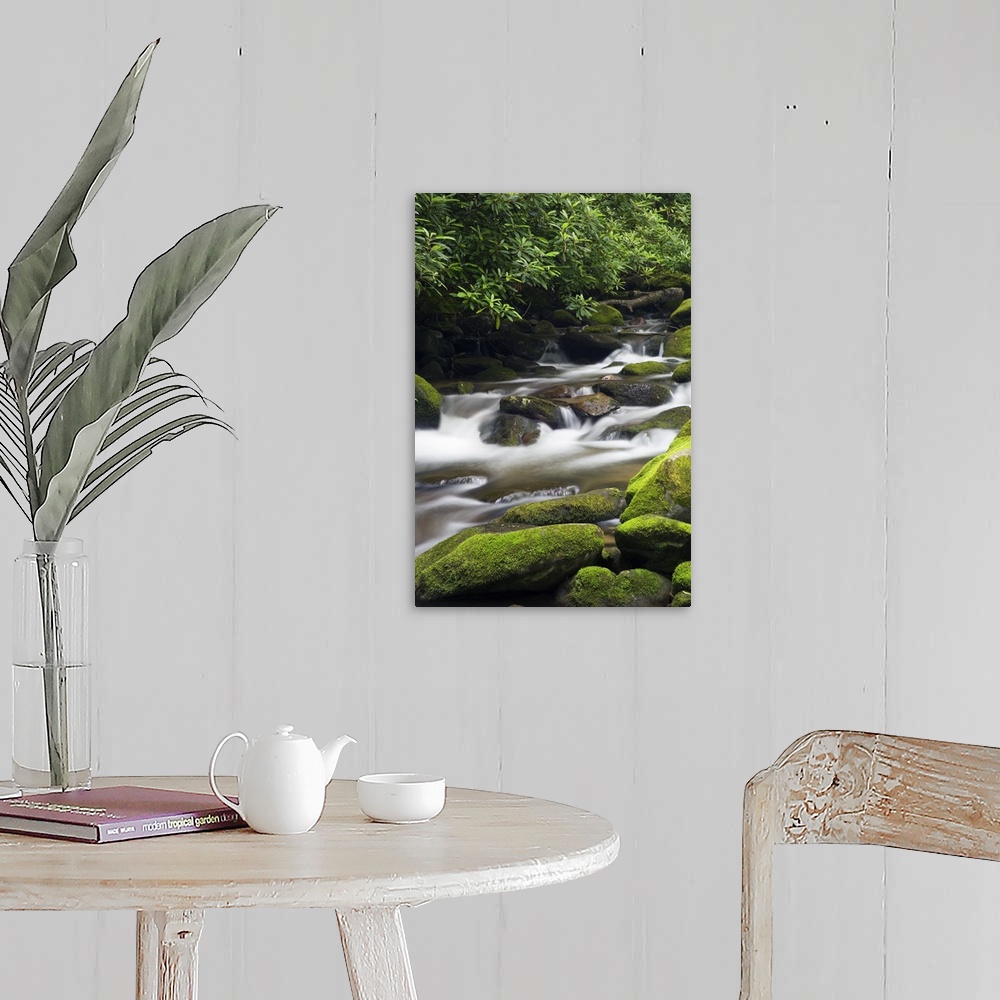 A farmhouse room featuring Giant photograph shows fast-moving water traveling down a stream and over rocks of varying sizes,...
